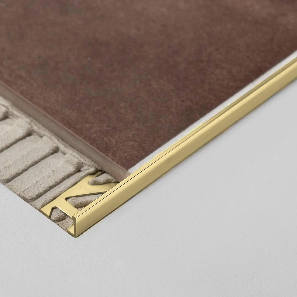DURAL angle profile brass natural installed as tile edging