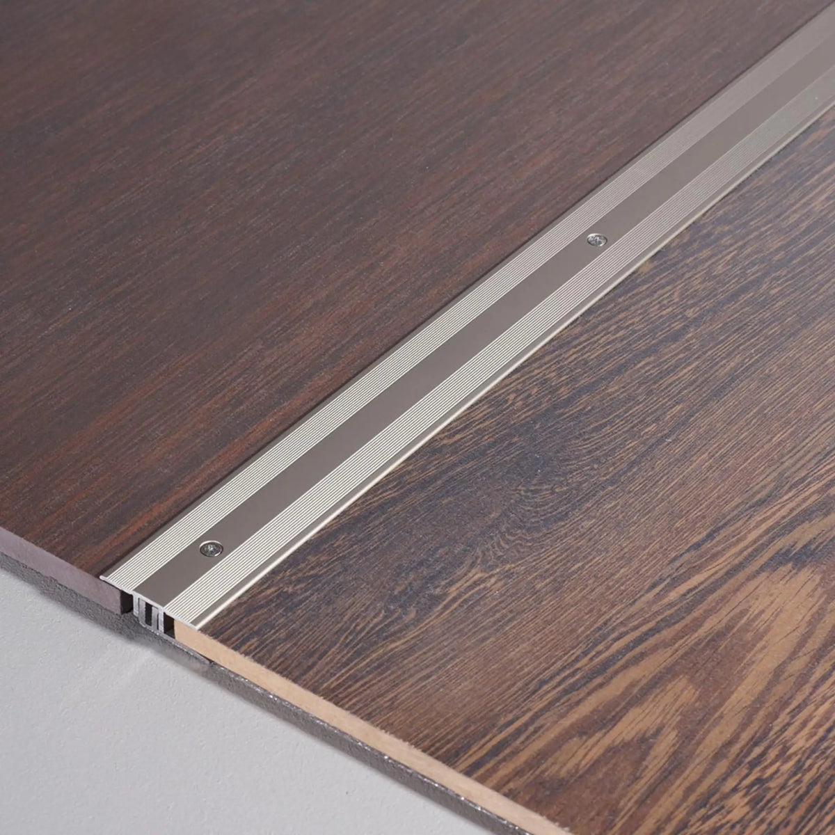 DURAL transition profile DUOFLOOR titanium with visible screws installed between parquet