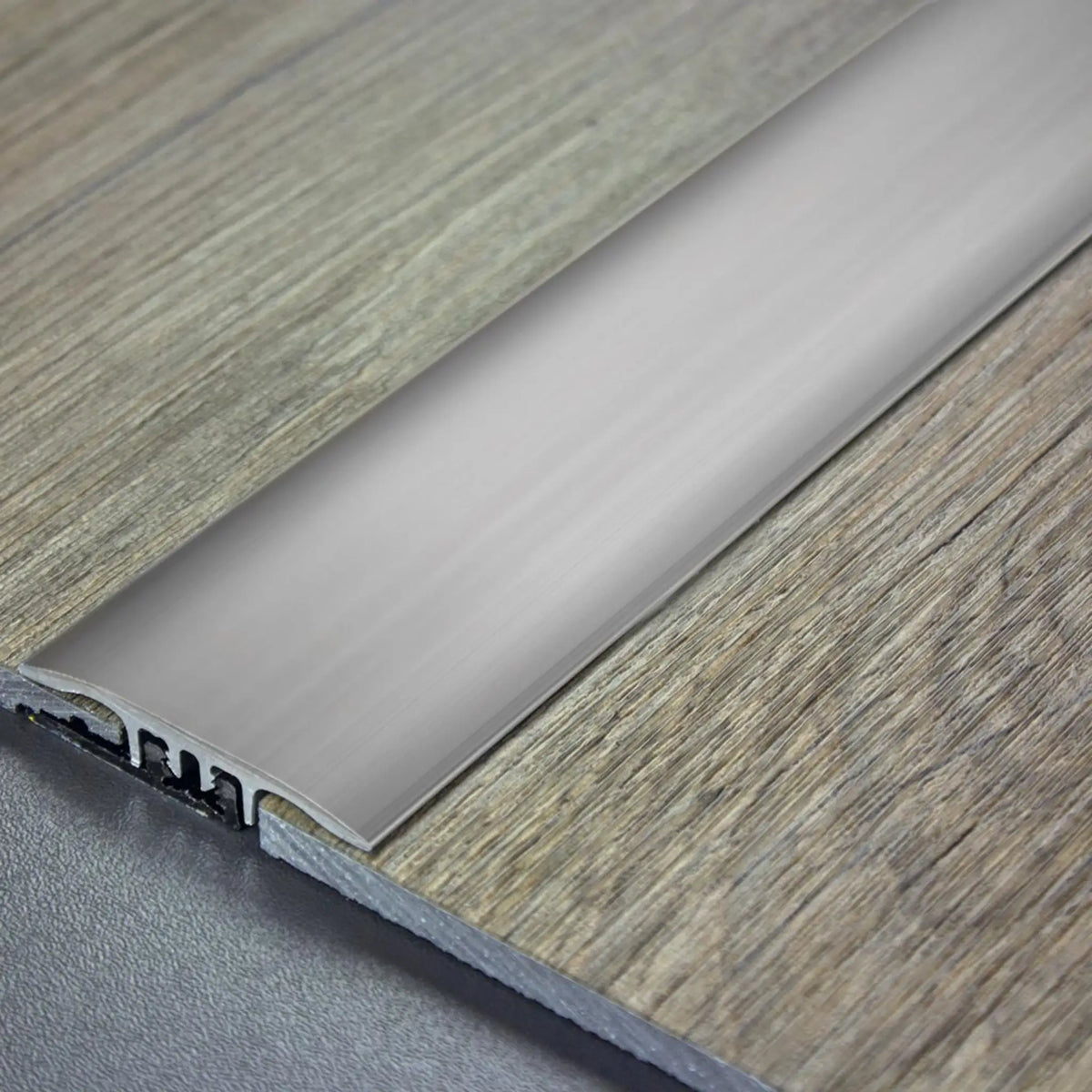 DURAL transition profile SNAP LVT titanium installed between two parquet floors