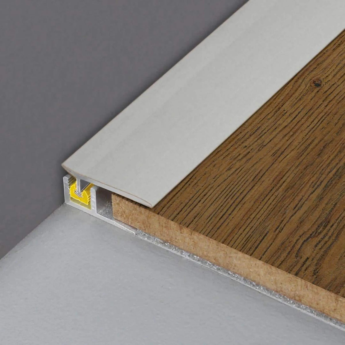 DURAL wall connection profile CLIPPER silver installed with parquet flooring