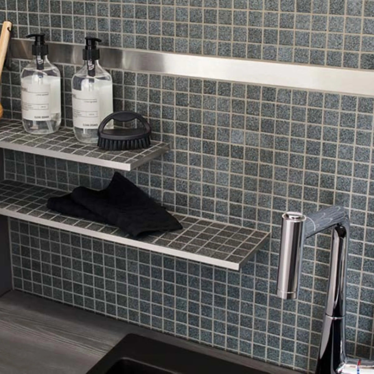 Decorative profile stainless steel polished glossy installed in the bathroom between mosaic tiles